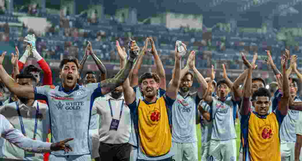 Kerala Blasters players celebrate after their win against Bengaluru FC in an ISL match.