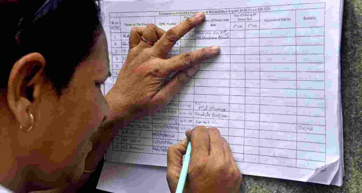 A woman fills out an enumeration form as part of the SIR process.