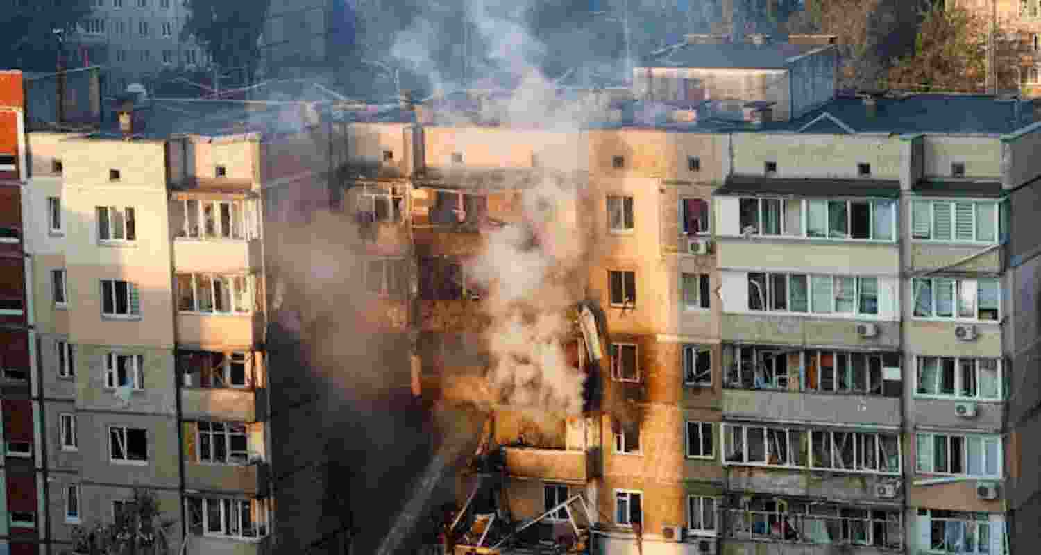 Emergency workers extinguish a fire in an apartment building that was damaged during a Russian drone strike.