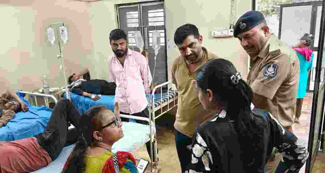 Relatives of patients speak to each other at a hospital in Bhavnagar following the suspected spurious liquor incident.