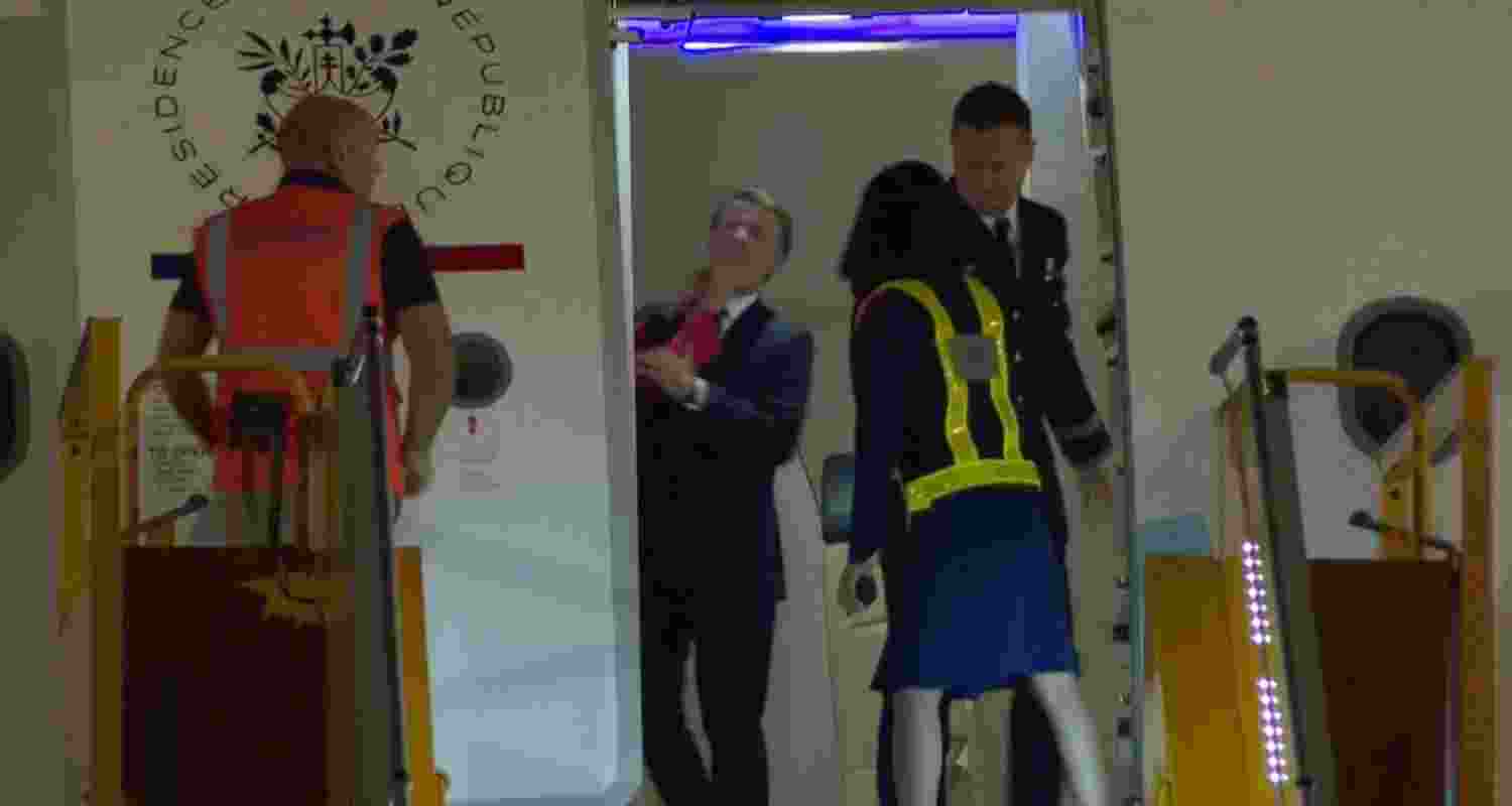 A video shows French President Macron's face being shoved by his wife as they land in Vietnam.