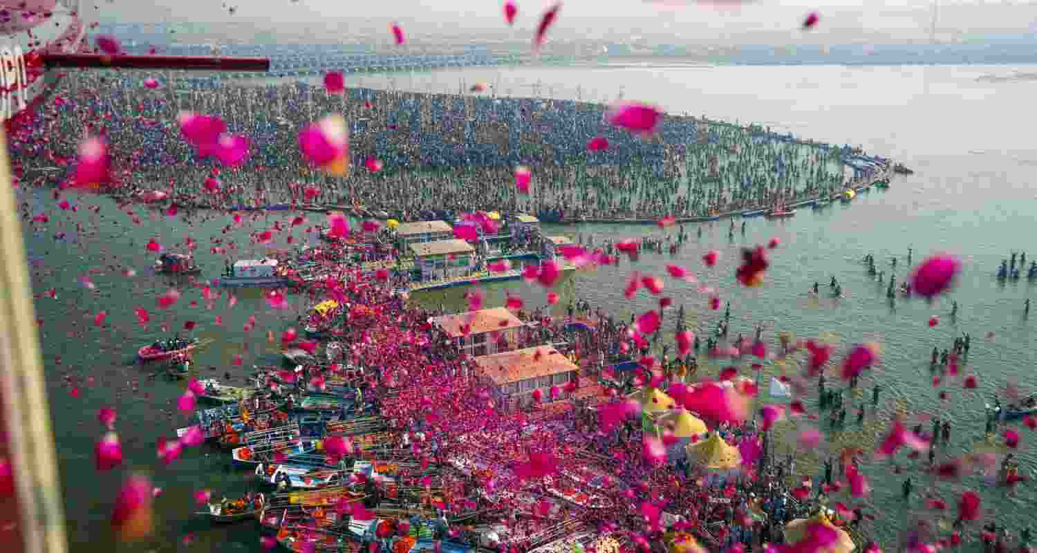 Flower petals being showered at devotees during the Mahakumbh at the Triveni Sangam in Prayagraj.