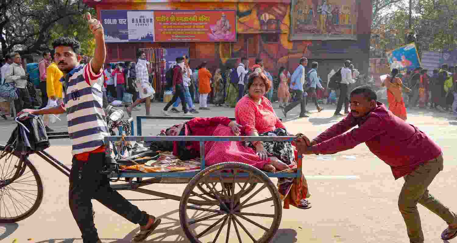 Devotees ride a rear loading cycle rickshaw during the ongoing Mahakumbh Mela, in Prayagraj, Uttar Pradesh, Tuesday.