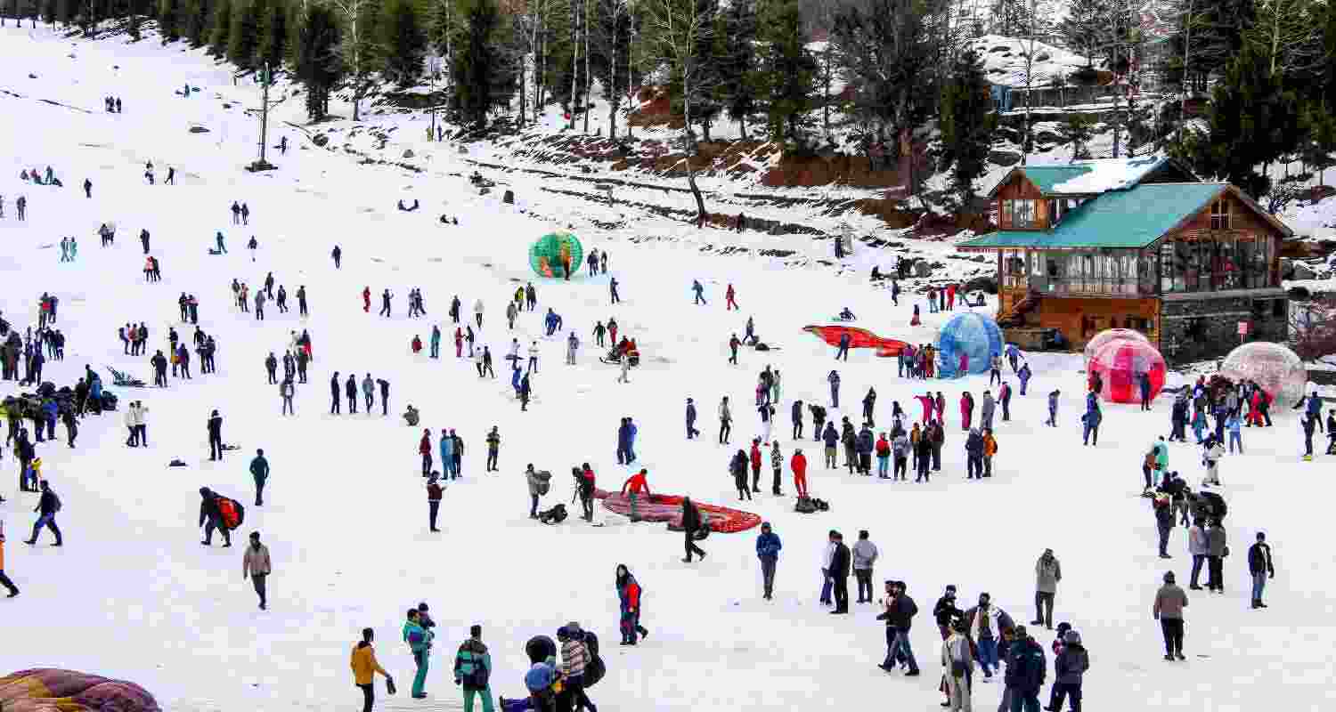 Tourists enjoy after fresh snowfall, at the Solang Valley in Manali, Saturday. 