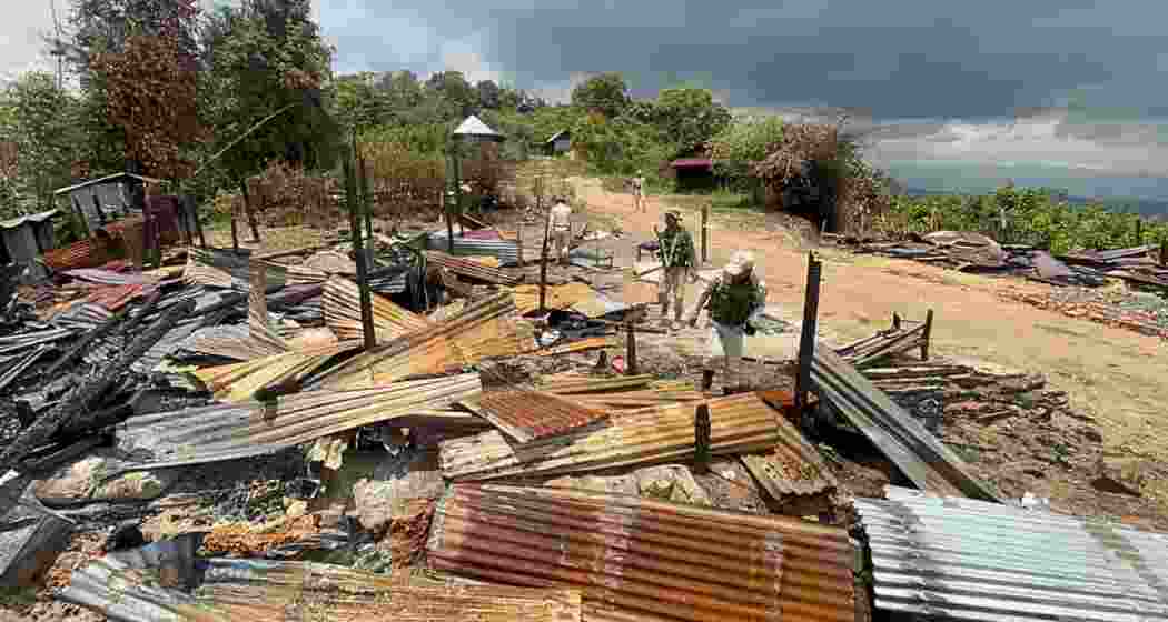 Police inspect burnt houses in Manipur’s Kamjong district after armed militants attacked border villages, forcing residents to flee into nearby forests
