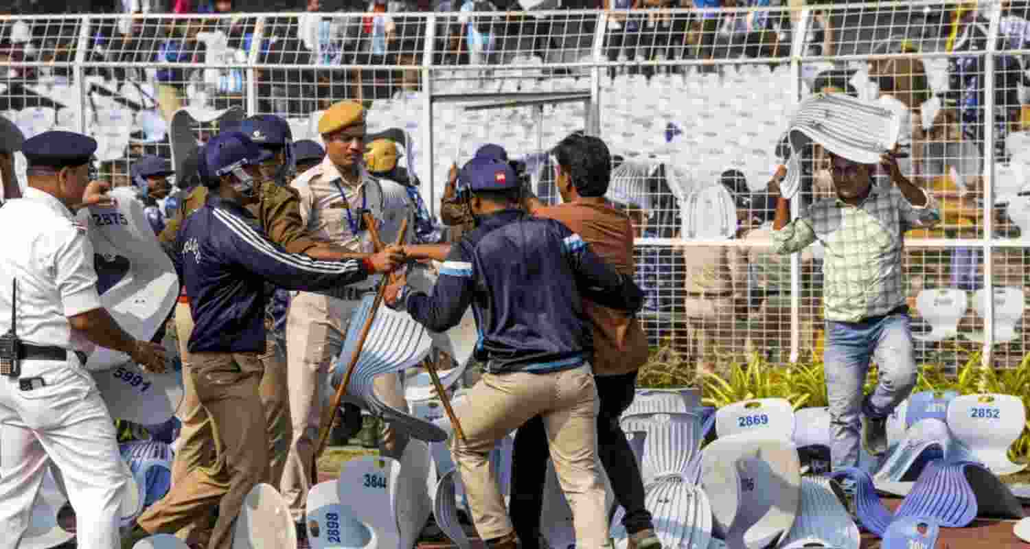 Security personnel try to stop a person amid chaos during an event of Argentine footballer Lionel Messi as part of his 'G.O.A.T. India Tour 2025', at Vivekananda Yuba Bharati Krirangan (VYBK), in Kolkata, Saturday. (File Photo)