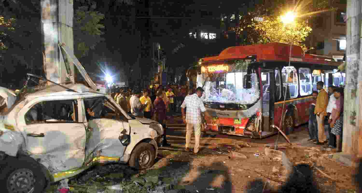 People gather near the wreckage of vehicles after a Brihanmumbai Electric Supply and Transport (BEST) undertaking's bus rammed into pedestrians as well as vehicles on a road at Kurla, in Mumbai, Monday.