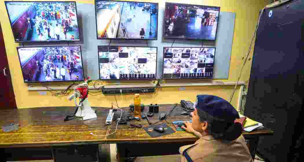 A police official keeps a vigil through CCTV cameras from a control room, ahead of the NEET-UG re-examination, at the Charbagh Railway Station, in Lucknow, Uttar Pradesh, on Saturday.