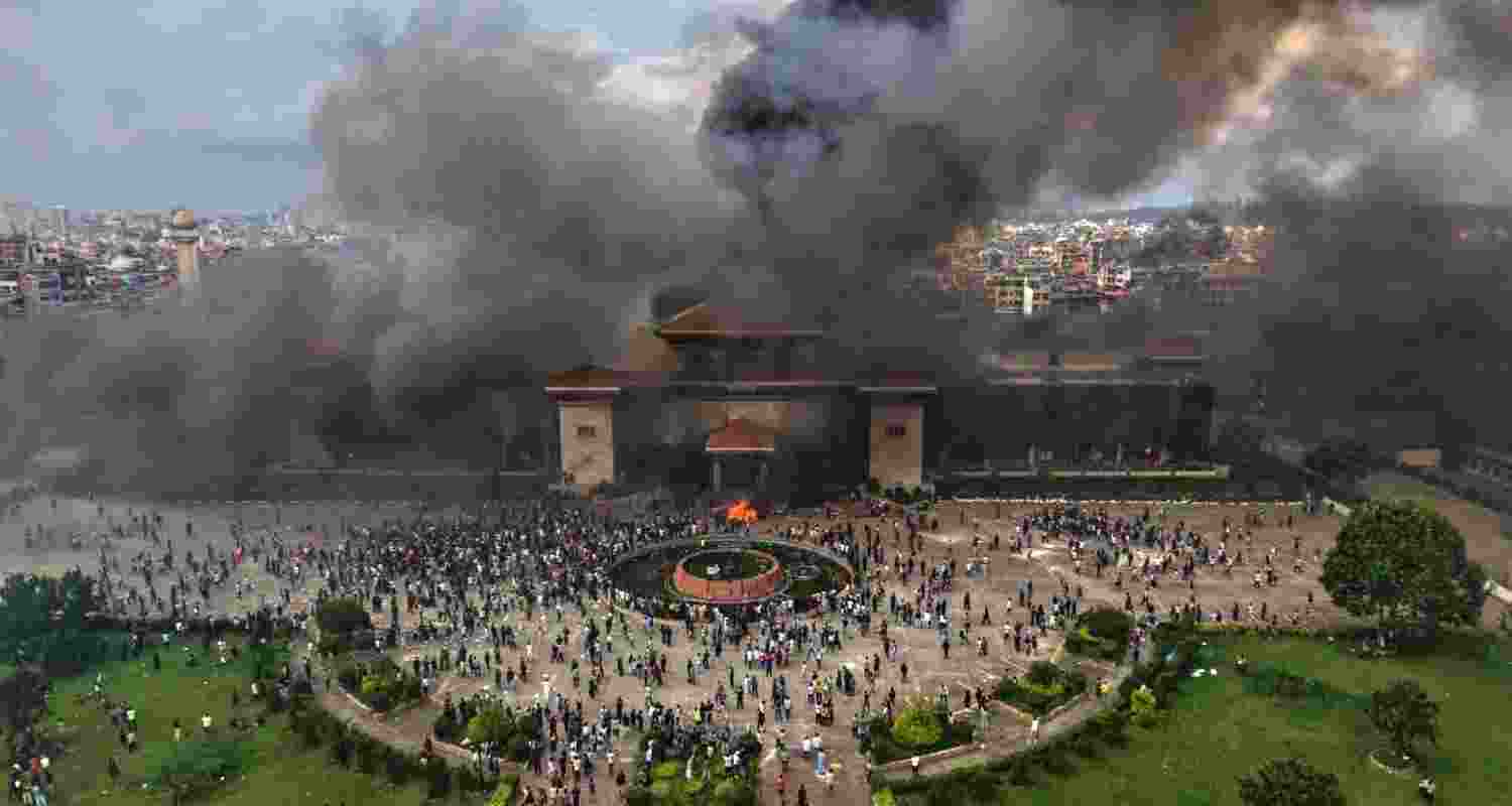 Smoke rising from the Federal Parliament of Nepal after it was set on fire by protesters during massive anti-government protests, in Kathmandu, Nepal, on September 9.