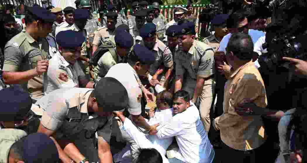 Congress Legislature Party leader RC Kadam being lifted by police while Congress MP Saptagiri Ulaka is denied entry to the Odisha Assembly amid protests and chaos.
