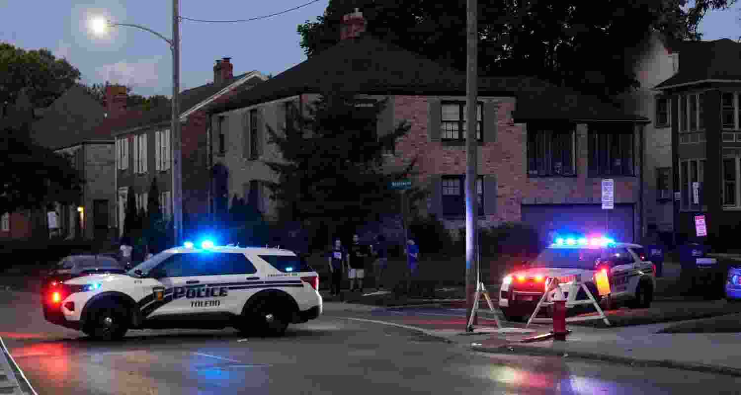 Police stand near where multiple people were shot at a community festival at the Agnes Reynolds Jackson Arboretum Saturday, June 6, 2026, in Toledo, Ohio.