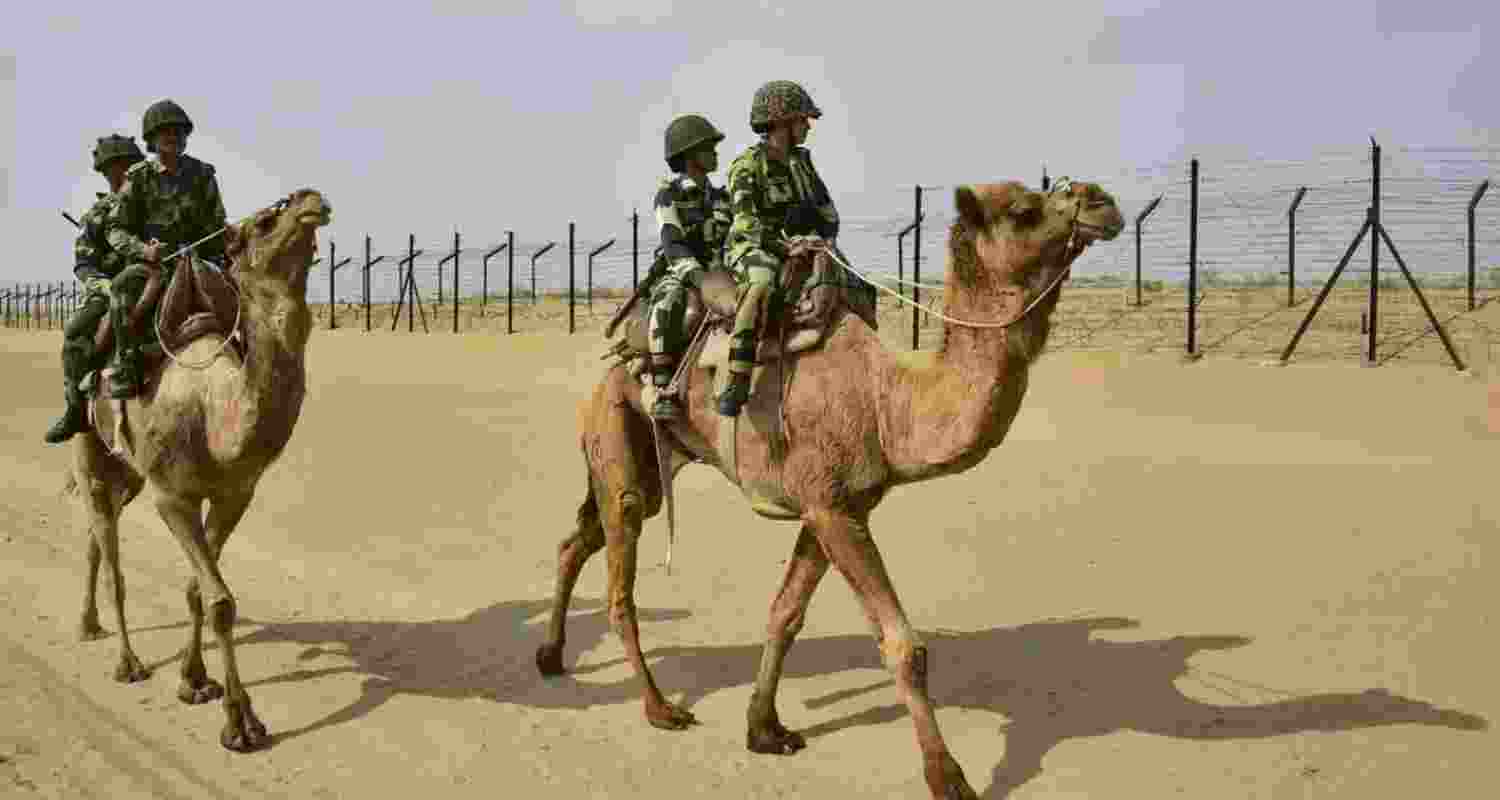 BSF jawans mounted on camels patrol the international border between India and Pakistan in Rajasthan. BSF jawans mounted on camels patrol the international border between India and Pakistan in Rajasthan.