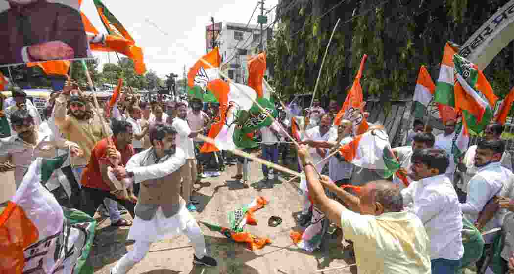 Supporters of BJP and Congress clash during a protest against the objectionable comments made against Prime Minister Narendra Modi by a man during a rally under 'Vote Adhikar Yatra', outside Bihar Pradesh Congress Committee office, in Patna, Friday.