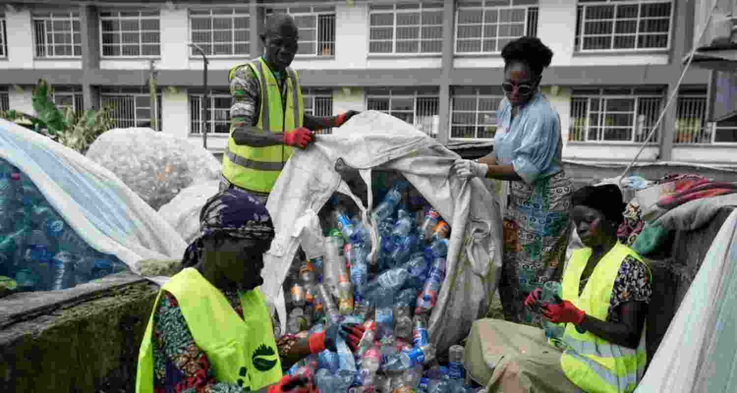 Omoh Alokwe, co-founder of Street Waste Company, sorts out different soft-drink plastic bottles along with workers in Lagos, Nigeria. Omoh Alokwe, co-founder of Street Waste Company, sorts out different soft-drink plastic bottles along with workers in Lagos, Nigeria.