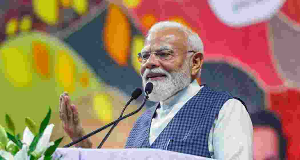 Prime Minister Narendra Modi addresses the inauguration and laying of foundation stones of various development projects, in Surat district, Gujarat on Friday.