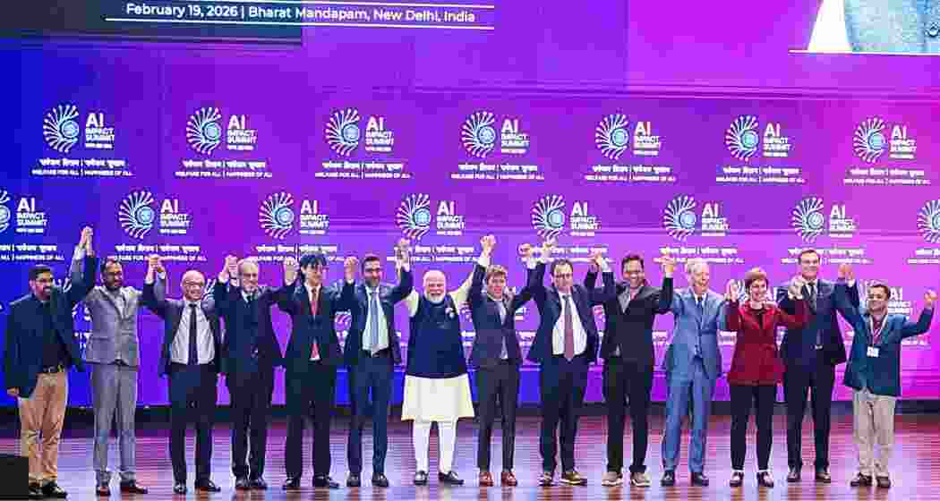 PM Modi with tech leaders at the Impact AI Summit.