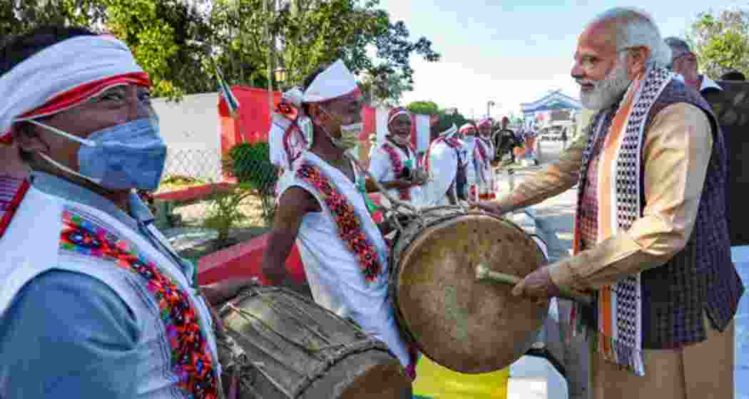 PM Modi being welcomed by folk artistes on his arrival in Imphal, Manipur, in 2022.