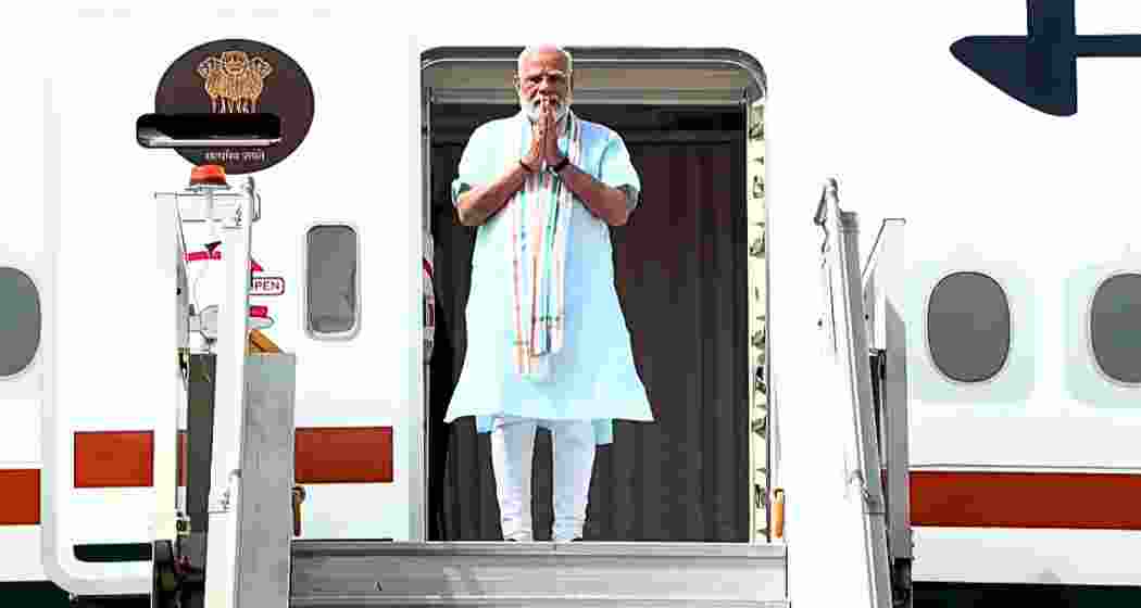Prime Minister Narendra Modi greets supporters after returning to New Delhi following his five-nation tour of the UAE, the Netherlands, Sweden, Norway and Italy, on Thursday.