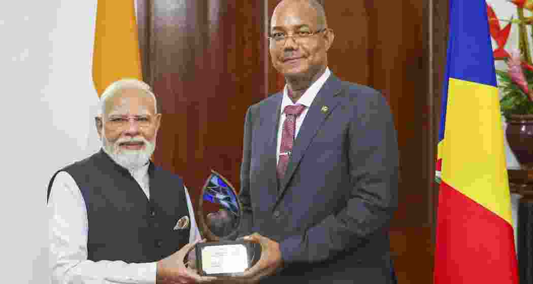  Prime Minister Narendra Modi receives the 'Guardian of the Blue Horizon' from Seychelles President Patrick Herminie, in Seychelles.