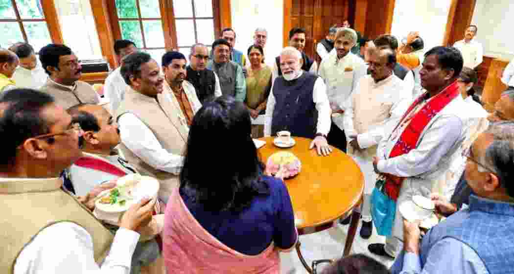 Prime Minister Narendra Modi interacts with Rajya Sabha members during a breakfast meeting at Parliament House in New Delhi on Thursday.
