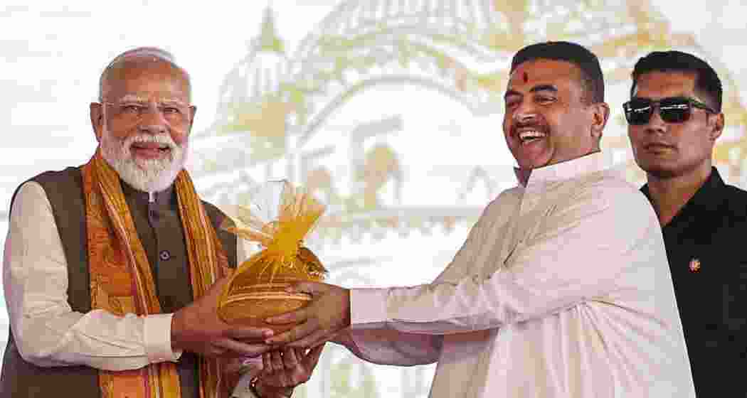 Prime Minister Narendra Modi being greeted by West Bengal Chief Minister Suvendu Adhikari during the 'Paschimbanga Divas', West Bengal Day, celebration at Tarakeswar, in Hooghly district, West Bengal on Saturday.