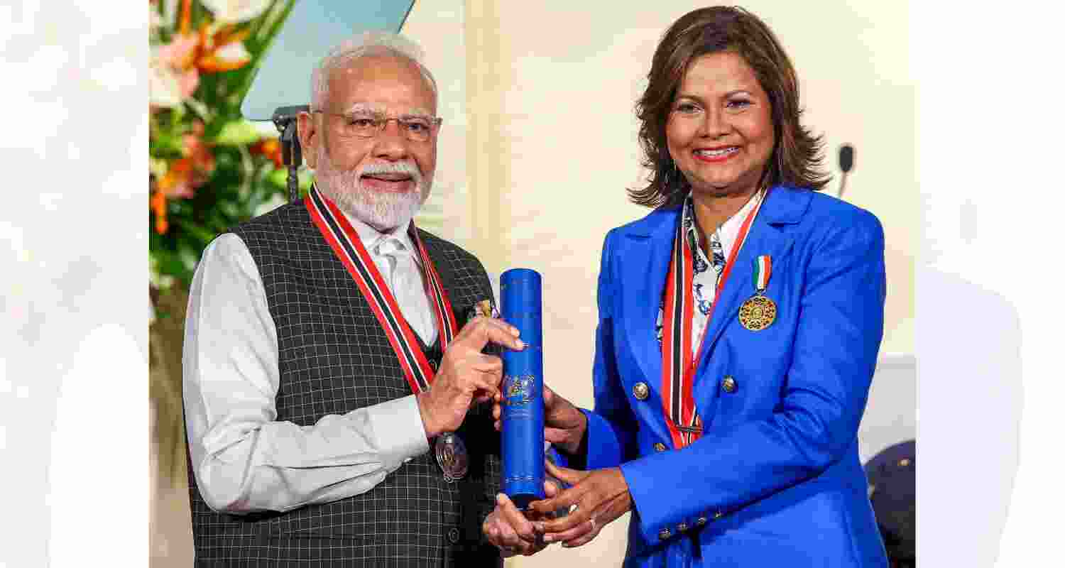 Prime Minister Narendra Modi being conferred with 'The Order of the Republic of Trinidad and Tobago' - the country's highest civilian honour, by Trinidad and Tobago President Christine Carla Kangaloo during a ceremony at the President�s House, in Trinidad and Tobago.