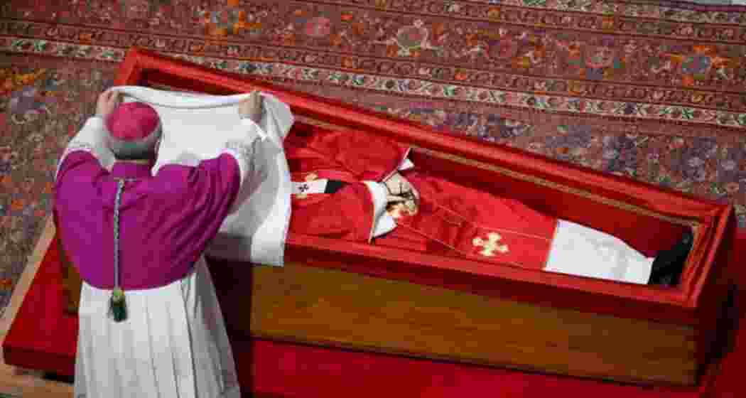 Cardinal Kevin Farrell, Camerlengo of the Holy Roman Church, places a white silk cloth over the face of Pope Francis during the private sealing of his coffin at St. Peter’s Basilica on Friday.