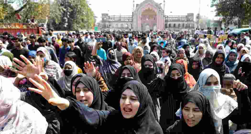 Shia mourners hold posters of Ayatollah Ali Khamenei and raise slogans during a protest march in Lucknow on Sunday, condemning his killing in a US-Israel strike and observing mourning.