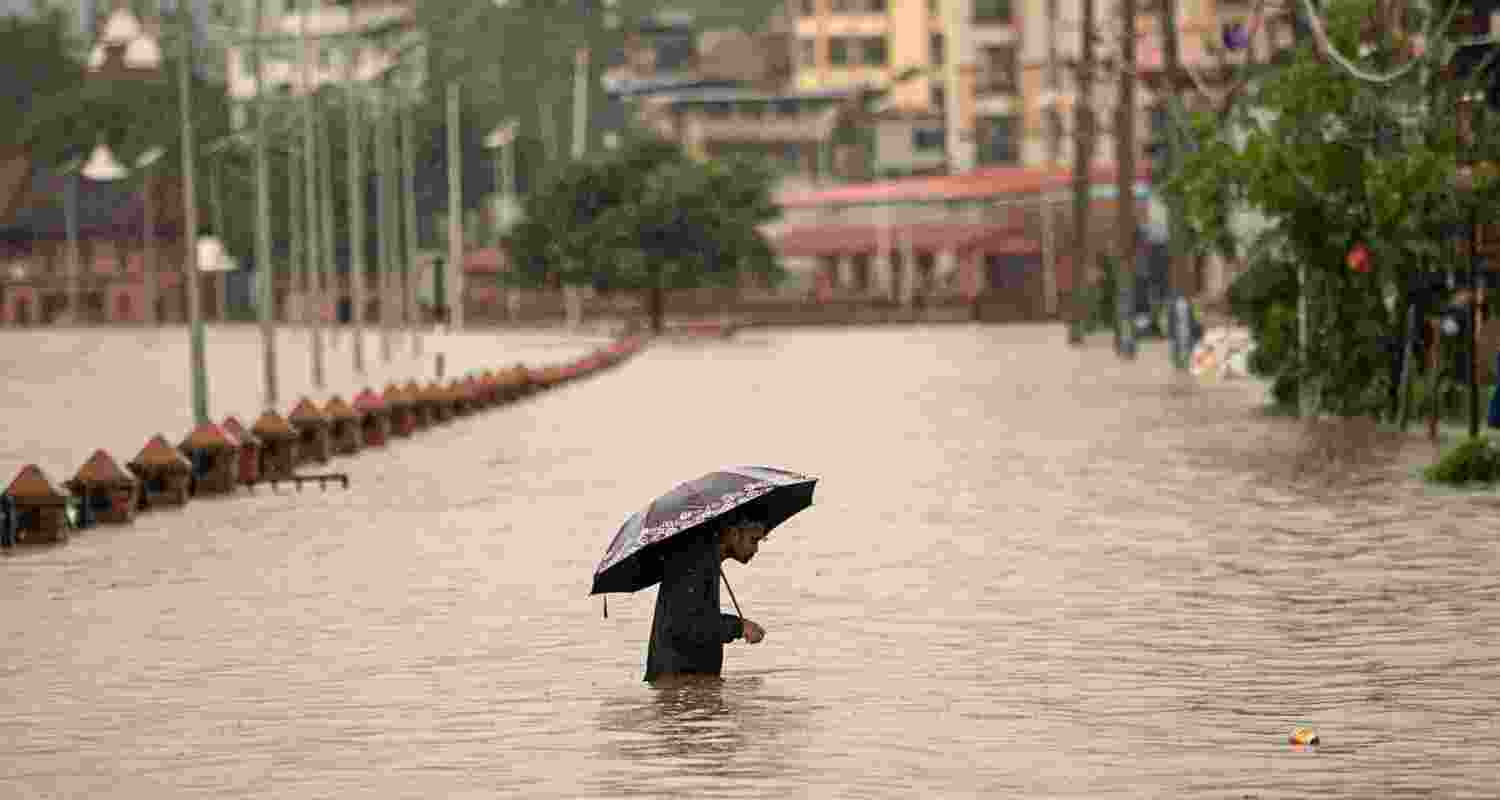 A man walks through floodwaters in Kathmandu.