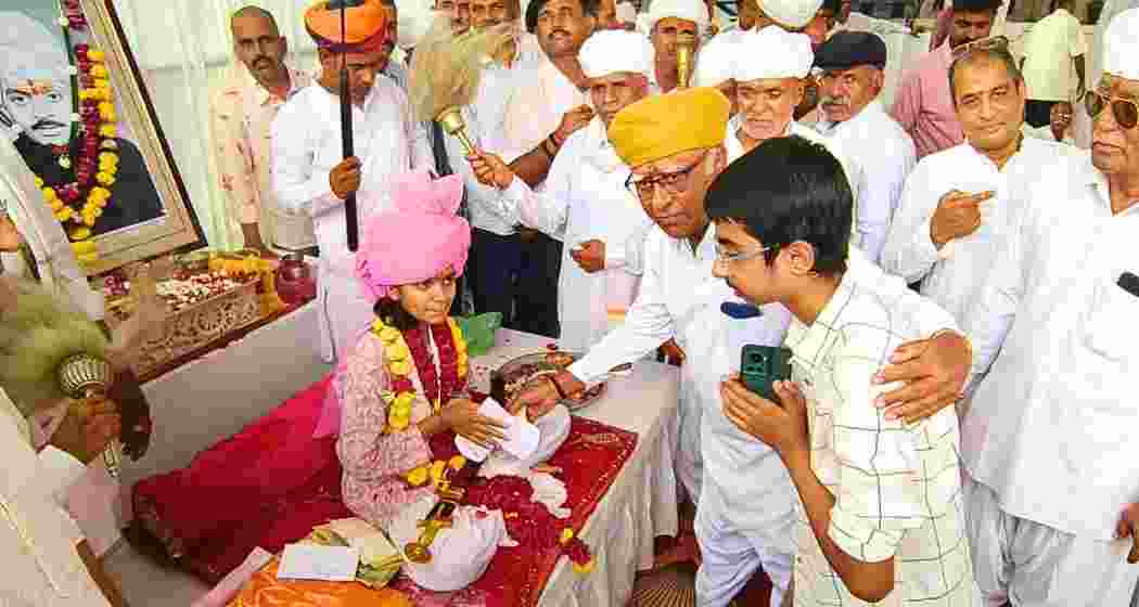 People greet Tejaswi Kumari Jodha as she wears the ceremonial turban during the traditional "Paag Ka Dastoor" at Kherwa Fort after becoming the first girl declared heir to the Kherwagarh lineage.
