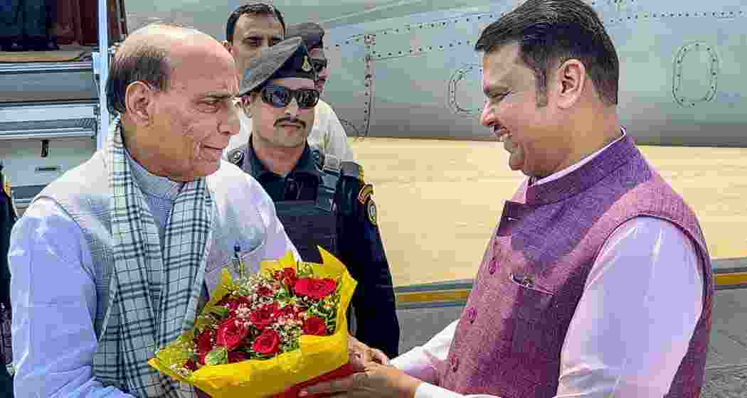 Union Defence Minister Rajnath Singh, left, being welcomed by Maharashtra Chief Minister Devendra Fadnavis upon his arrival, in Shirdi, Ahilyanagar district, Maharashtra on Saturday. (@CMOMaharashtra/X via PTI Photo)