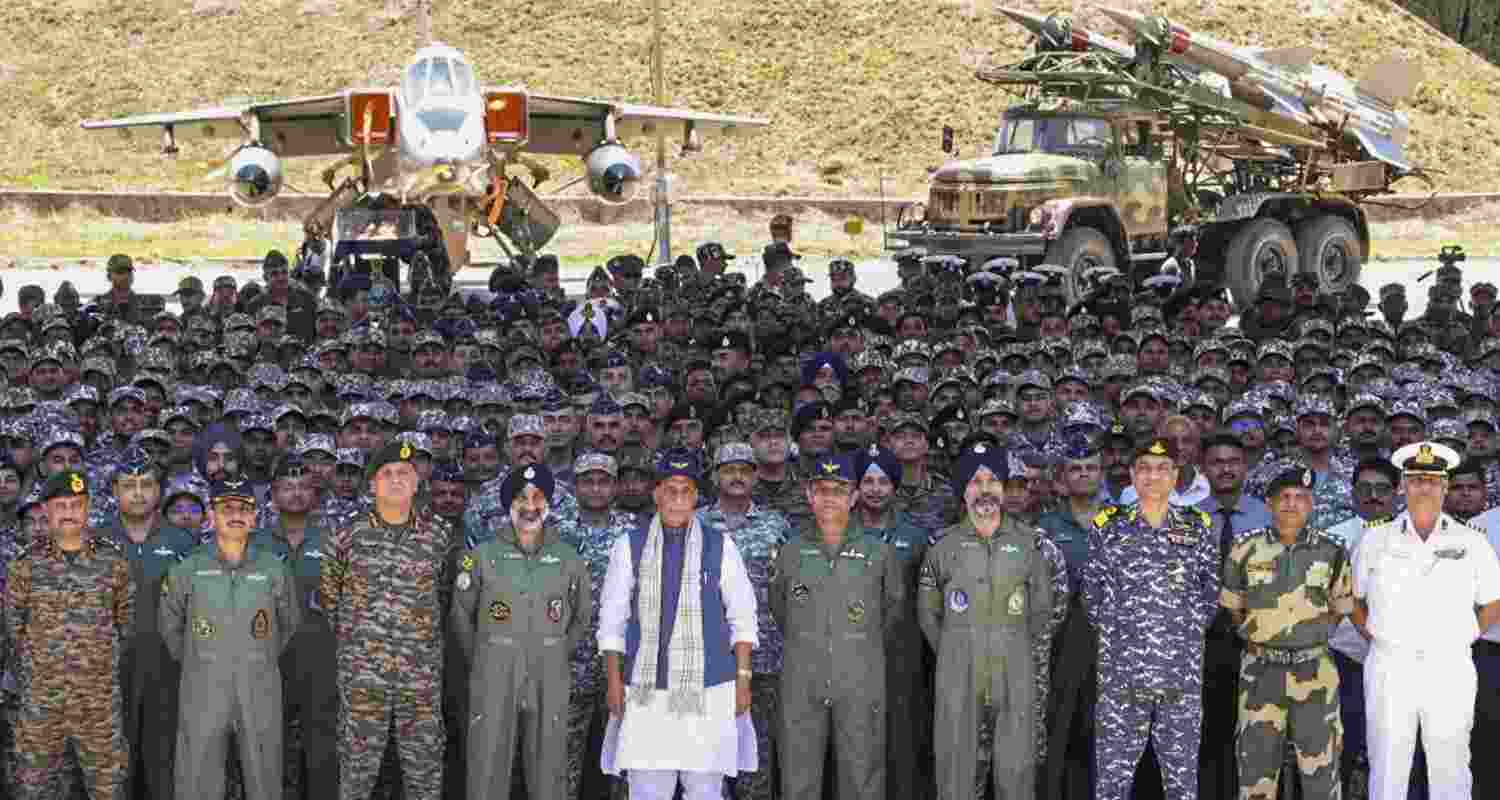 Defence Minister Rajnath Singh  poses for a group picture with armed forces personnel at the Bhuj air force station, in Kachchh district of Gujarat.