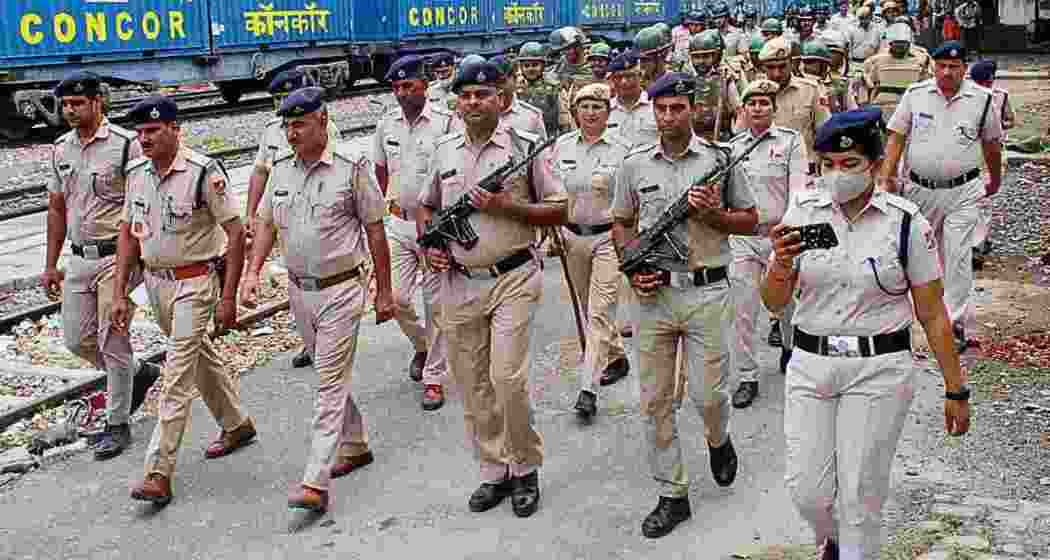 RPF officials on patrol at Tripura railway stations, ensuring passenger safety and preventing human trafficking during routine checks.