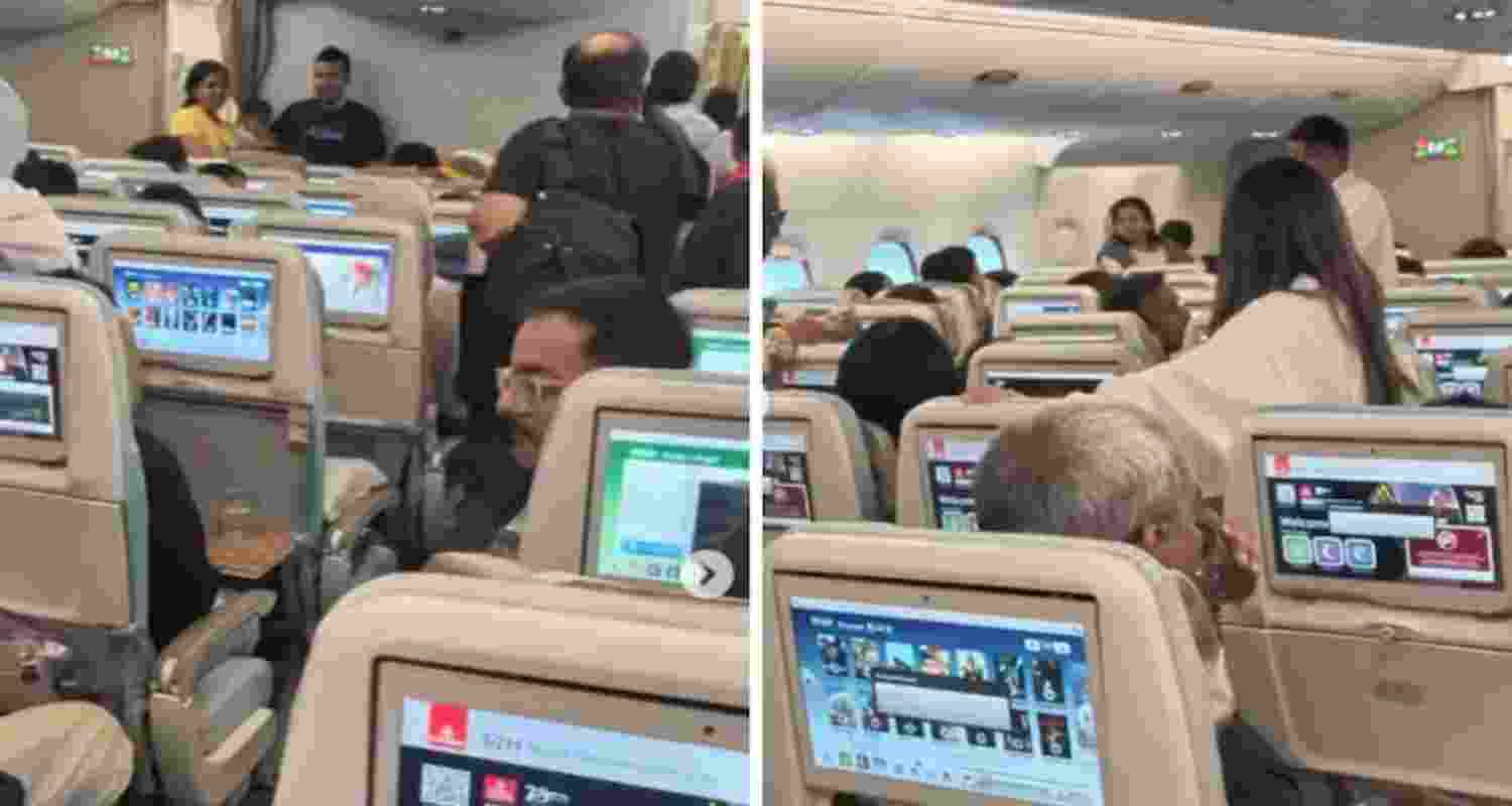 Passengers are seen standing in the aisles.