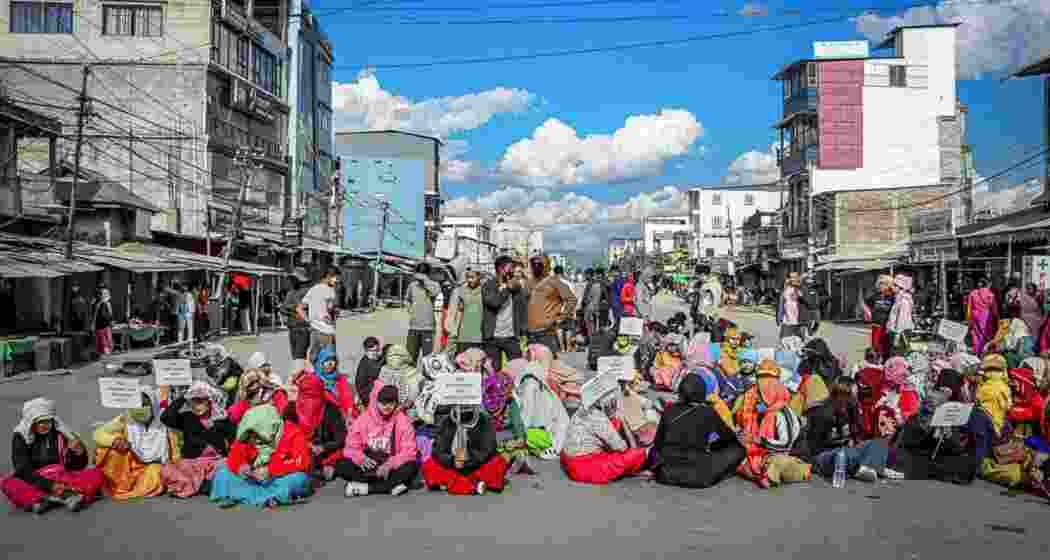 IDPs (Internally Displaced Persons) and people under the aegis of COCOMI (Coordinating Committee on Manipur Integrity) hold a protest, demanding rehabilitation on the opening day of the Sangai Festival 2025 Edition at Lamlong Bazar, in Imphal East.