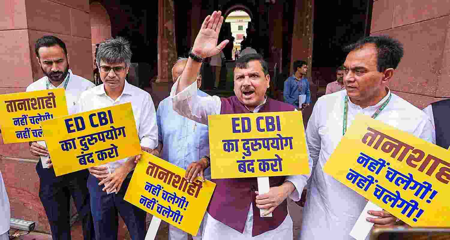 AAP leader Sanjay Singh along with other party leaders protests against the Central Government over the alleged misuse of CBI and Enforcement Directorate (ED) at the Parliament House complex, in New Delhi, Thursday. AAP leader Sanjay Singh along with other party leaders protests against the Central Government over the alleged misuse of CBI and Enforcement Directorate (ED) at the Parliament House complex, in New Delhi, Thursday.