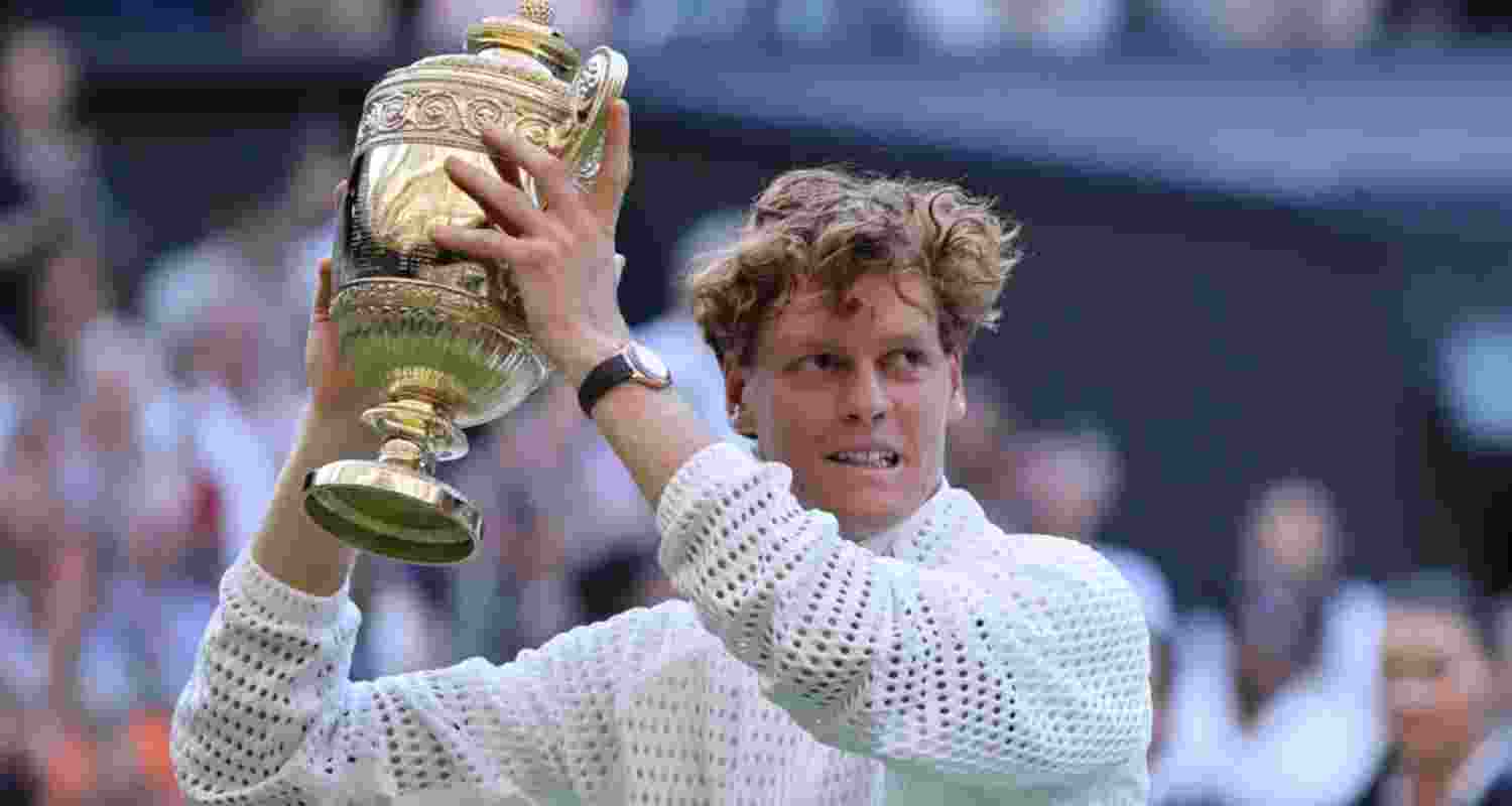 World Number 1 Jannik Sinner posing with the Wimbledon trophy.