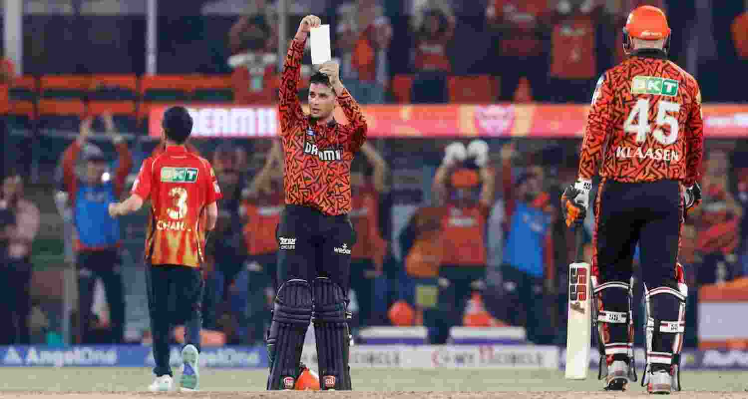 Opener Abhishek Sharma flashing a handwritten note after smashing a sensational century against Punjab Kings.