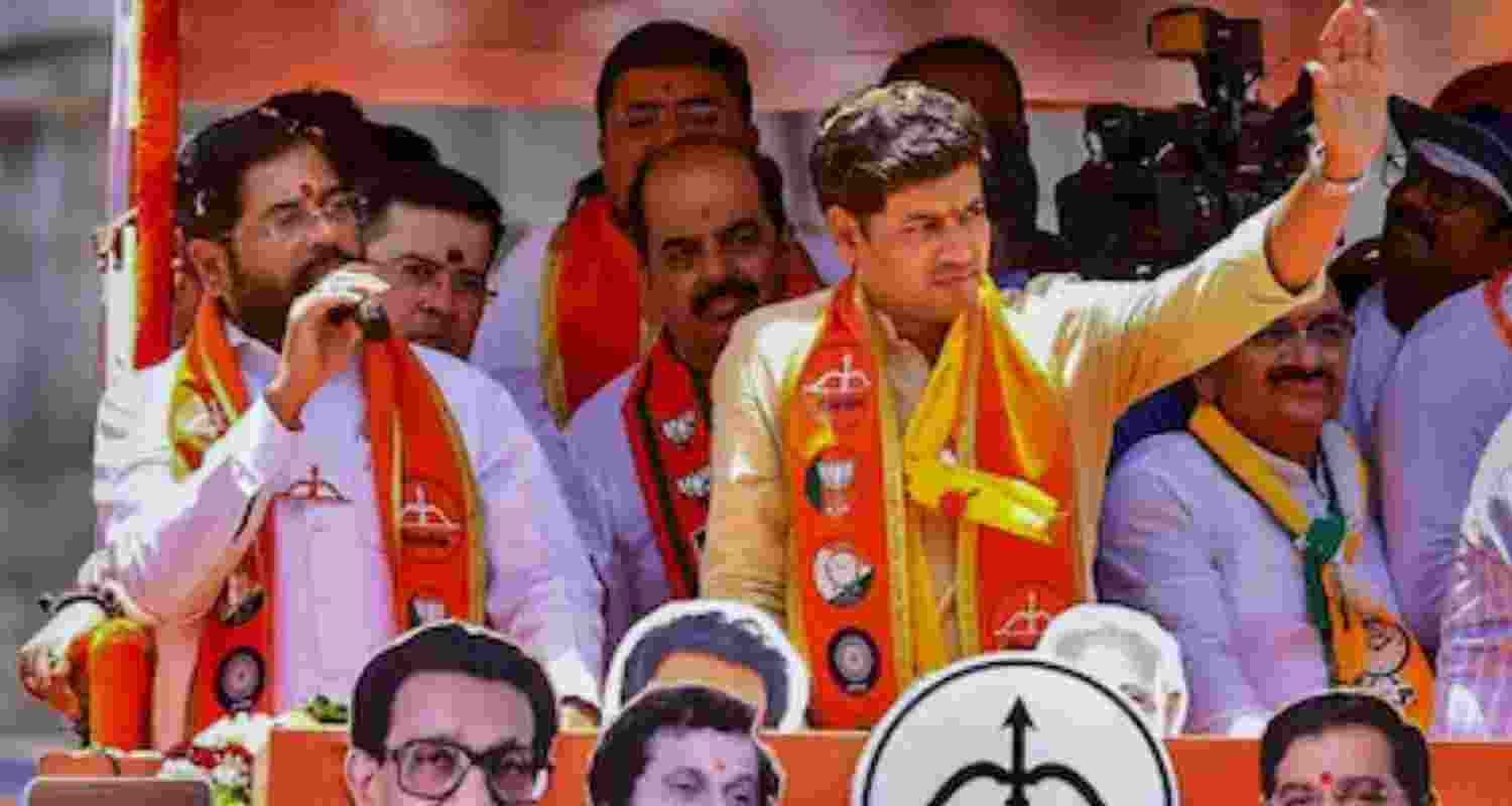 Eknath Shinde with his son Skrikant at a roadshow - file image.