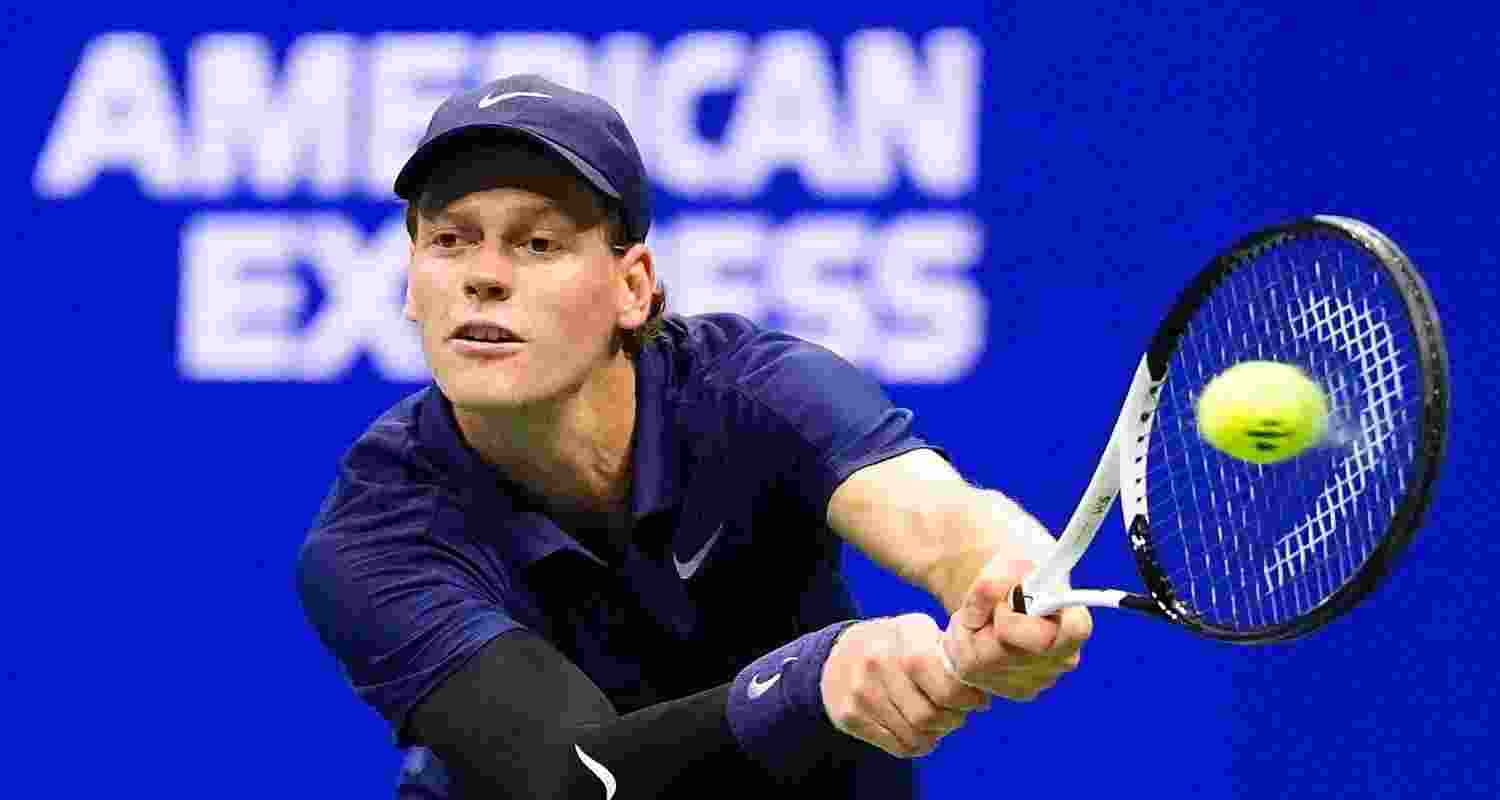 Jannik Sinner, of Italy, returns a shot to Felix Auger-Aliassime, of Canada, during the men's singles semifinals of the U.S. Open tennis championships, Friday.