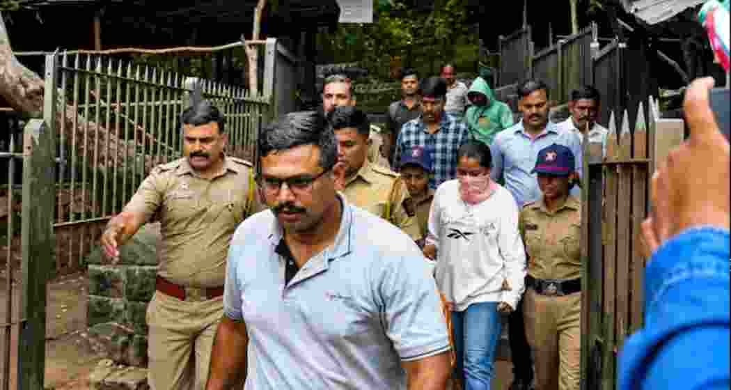 Police escort murder accused Siya Goyal during a crime scene reconstruction at Lohagad Fort in Pune district in connection with the alleged murder of realtor Ketan Agarwal.
