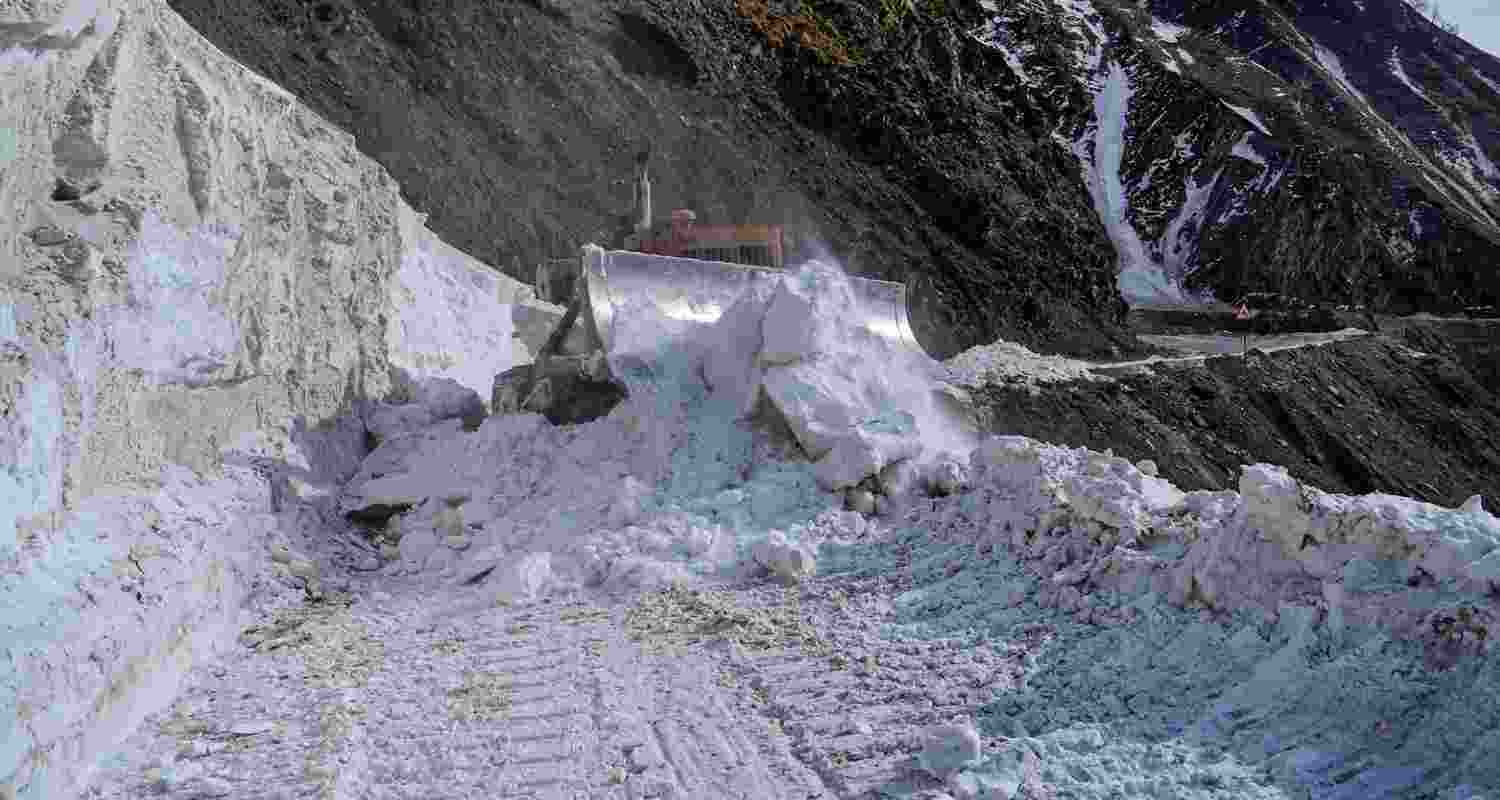 Heavy Snowfall on the road, an excavator attempts to clear out the snow