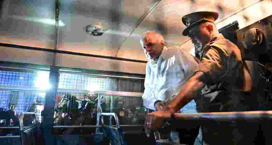 Ex-Sri Lanka president Wickremesinghe is seen inside a police van en route to Colombo Fort magistrate’s court on Saturday, following his arrest over alleged misuse of state funds. Ex-Sri Lanka president Wickremesinghe is seen inside a police van en route to Colombo Fort magistrate’s court on Saturday, following his arrest over alleged misuse of state funds.