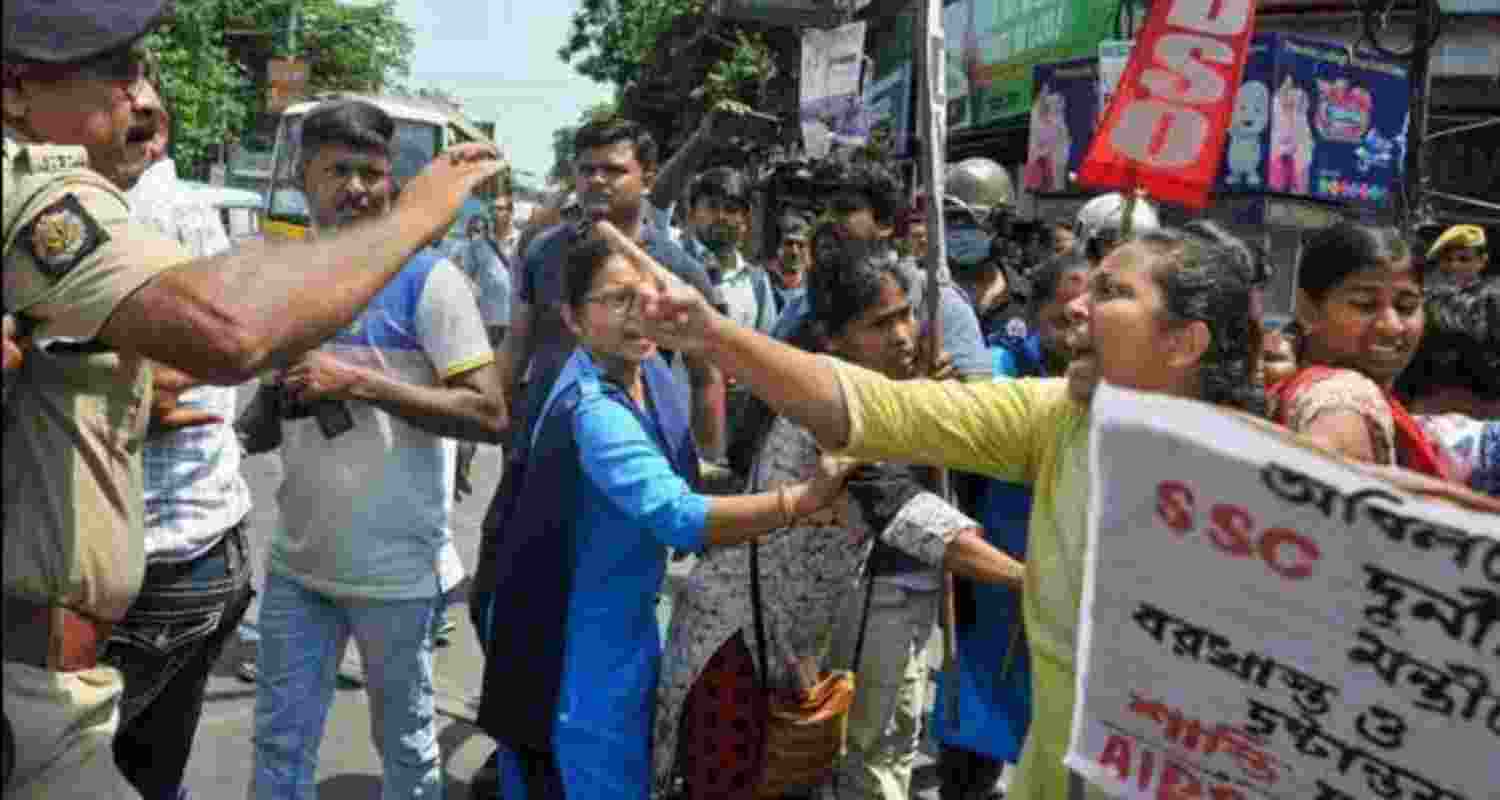 West Bengal Police personnel try to reason with members of the All India Democratic Youth Organisation (AIDYO) and All India Democratic Students' Organisation (AIDSO) during their protest march towards Chief Minister Mamata Banerjee's residence over state ministers' involvement in the SSC recruitment scam in Kolkata in the year 2022. West Bengal Police personnel try to reason with members of the All India Democratic Youth Organisation (AIDYO) and All India Democratic Students' Organisation (AIDSO) during their protest march towards Chief Minister Mamata Banerjee's residence over state ministers' involvement in the SSC recruitment scam in Kolkata in the year 2022.