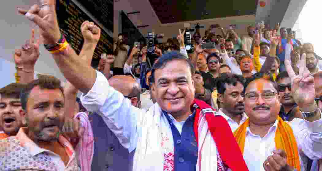  Assam Chief Minister Himanta Biswa Sarma with state BJP president Dilip Saikia shows victory sign during celebrations amid vote tabulation as the party leads in the Assembly elections, at the party headquarters, in Guwahati, Assam, on Monday.