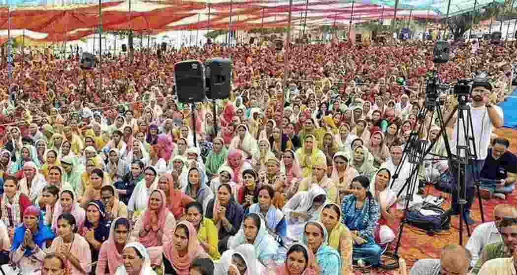 Devotees at the religious gathering where a stampede broke out In Hathras district. Devotees at the religious gathering where a stampede broke out In Hathras district.