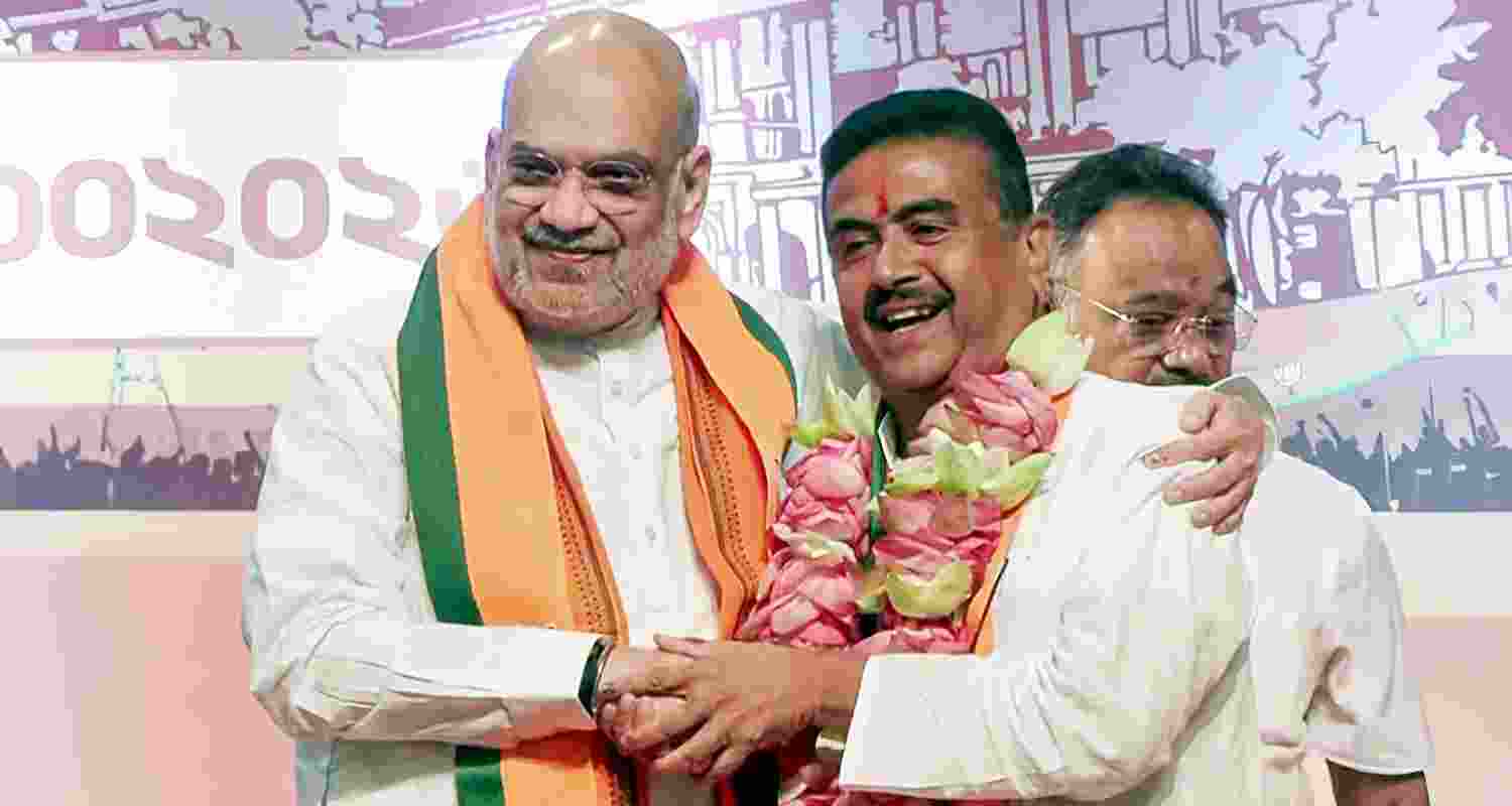 Union Home Minister Amit Shah with BJP leader Suvendu Adhikari during a press conference after the BJP legislature party meeting, in Kolkata, West Bengal, Friday. Adhikari was elected the leader of the BJP legislature party in West Bengal on Friday, paving the way for him to become the first BJP chief minister of the state.
