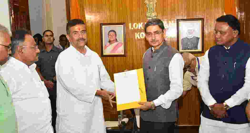 BJP leader Suvendu Adhikari meets Governor RN Ravi at Raj Bhavan in Kolkata after staking claim to form government in West Bengal on Friday.