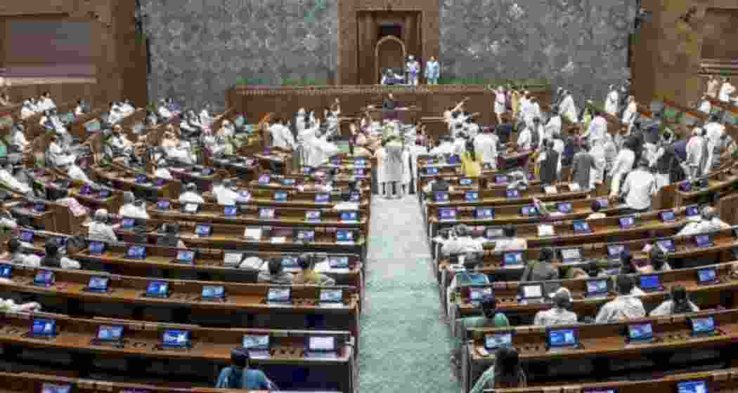 Opposition members protest in the well of the House amid proceedings in the Lok Sabha during the Monsoon Session of Parliament in New Delhi on Friday.