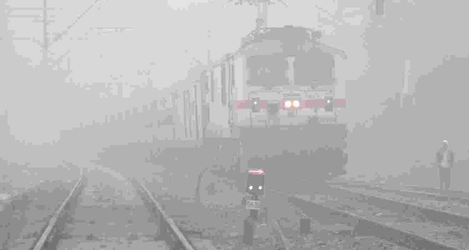 A train runs on a foggy day, in Gurugram, Wednesday. 